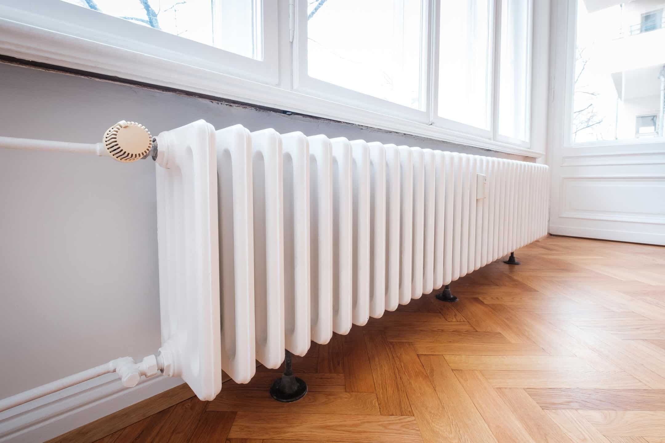 radiator heater-white radiator on wood flooring beneath a window radiator heater-white radiator on wood flooring beneath a window