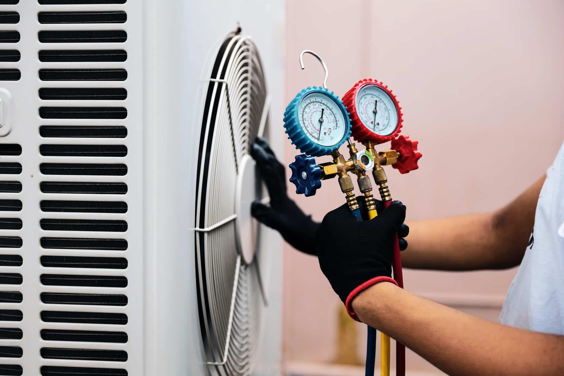 hvac refrigerant-tech using tool to measure refrigerant on hvac system hvac refrigerant-tech using tool to measure refrigerant on hvac system
