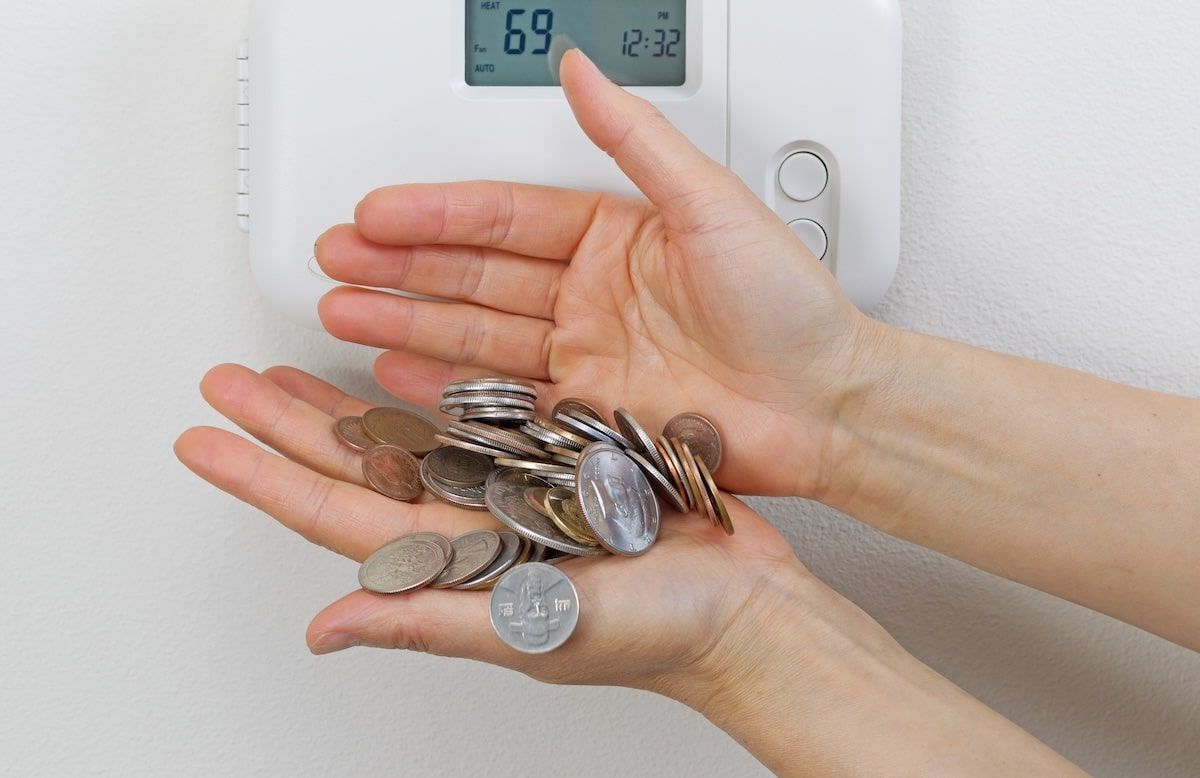 Close up of female hands spilling money due to heating costs. Financial loss of money concept. Close up of female hands spilling money due to heating costs. Financial loss of money concept.