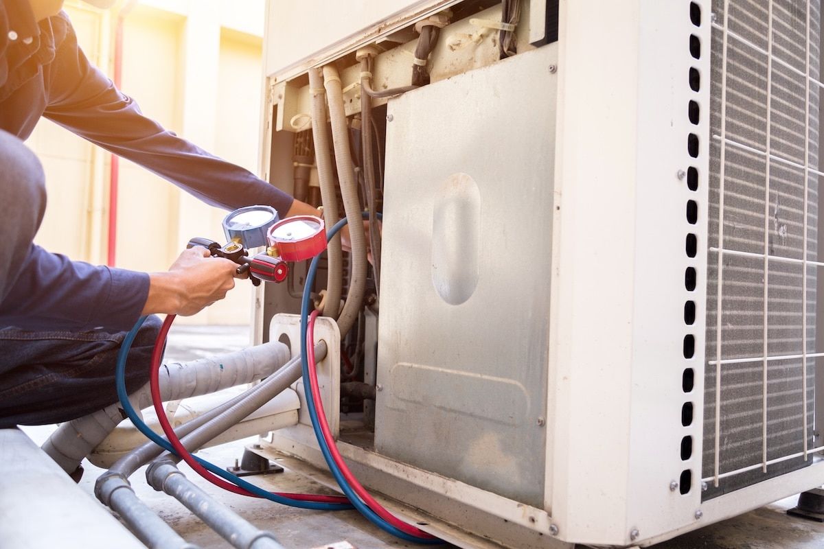 Technician is checking air conditioner ,measuring equipment for filling air conditioners. Technician is checking air conditioner ,measuring equipment for filling air conditioners.