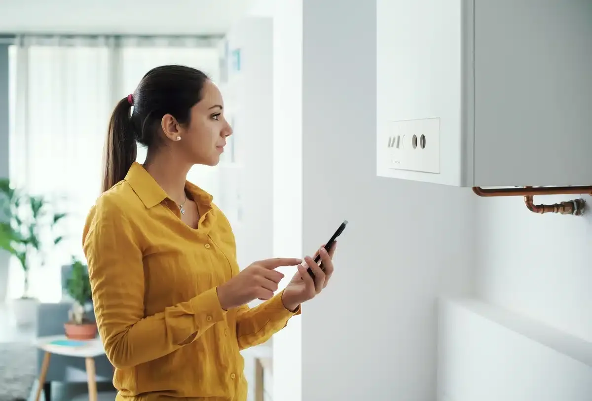 emergency furnace repair-woman looking at furnace emergency furnace repair-woman looking at furnace