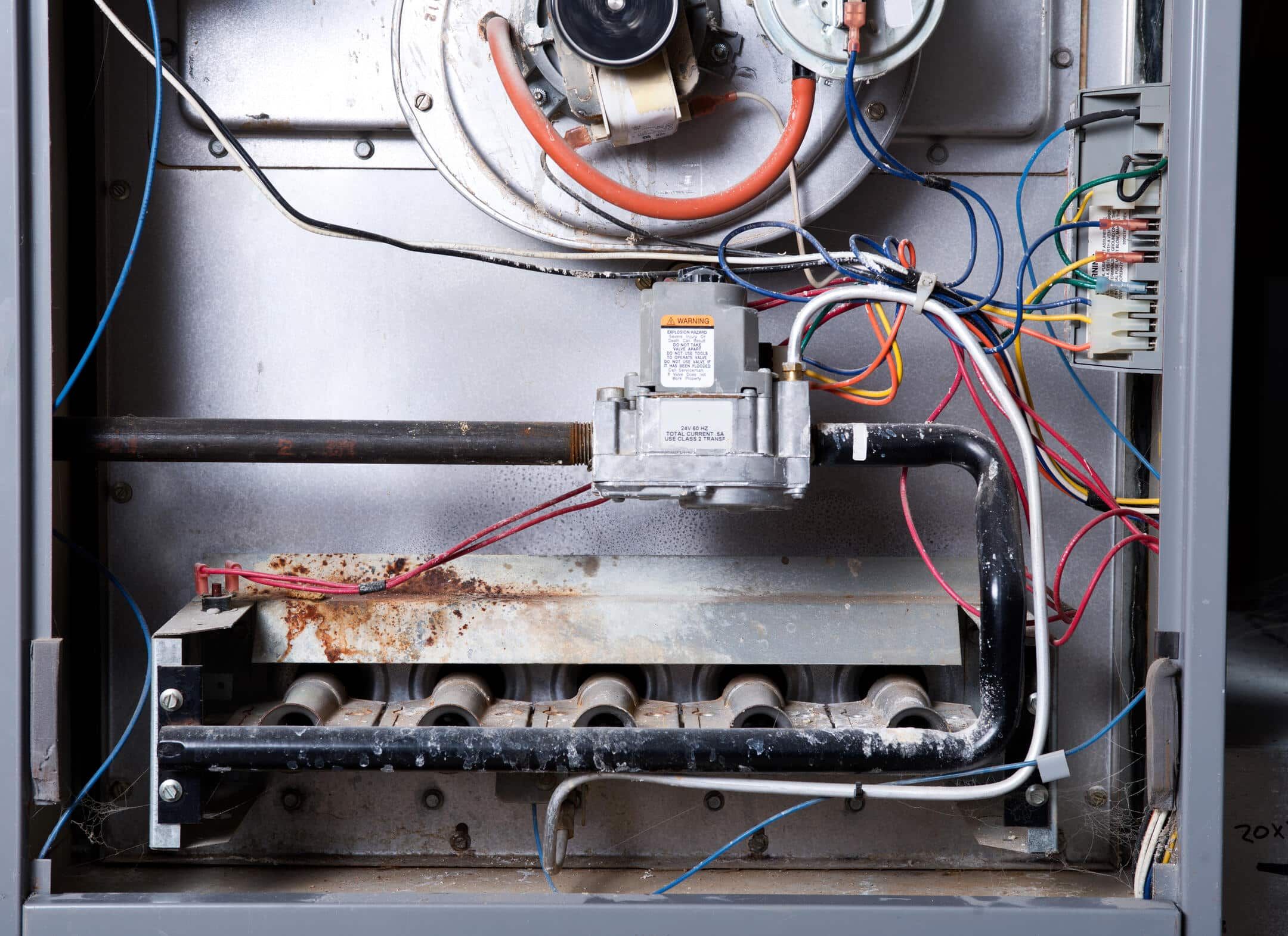 gas furnace replacement cost-close up of furnace parts needing maintenance or replacement gas furnace replacement cost-close up of furnace parts needing maintenance or replacement