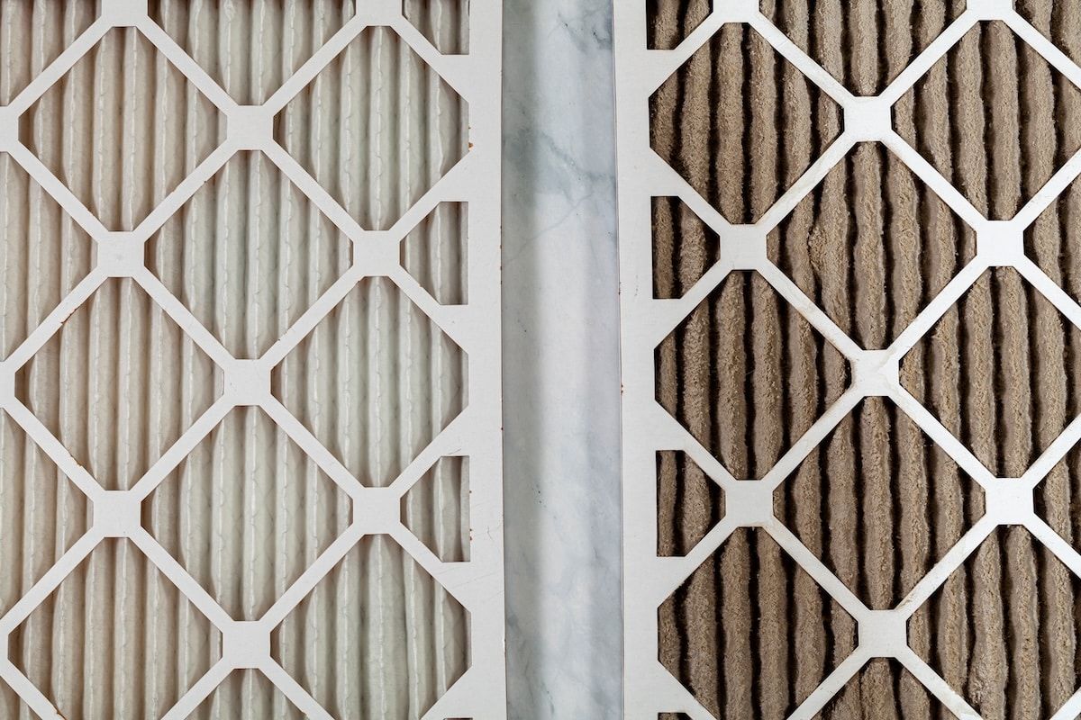 Side by side close up view of a new unused and an old heavily clogged dirty air filters. Image emphasizes the role of framed filters in improving air quality and preventing respiratory problems. Side by side close up view of a new unused and an old heavily clogged dirty air filters. Image emphasizes the role of framed filters in improving air quality and preventing respiratory problems.