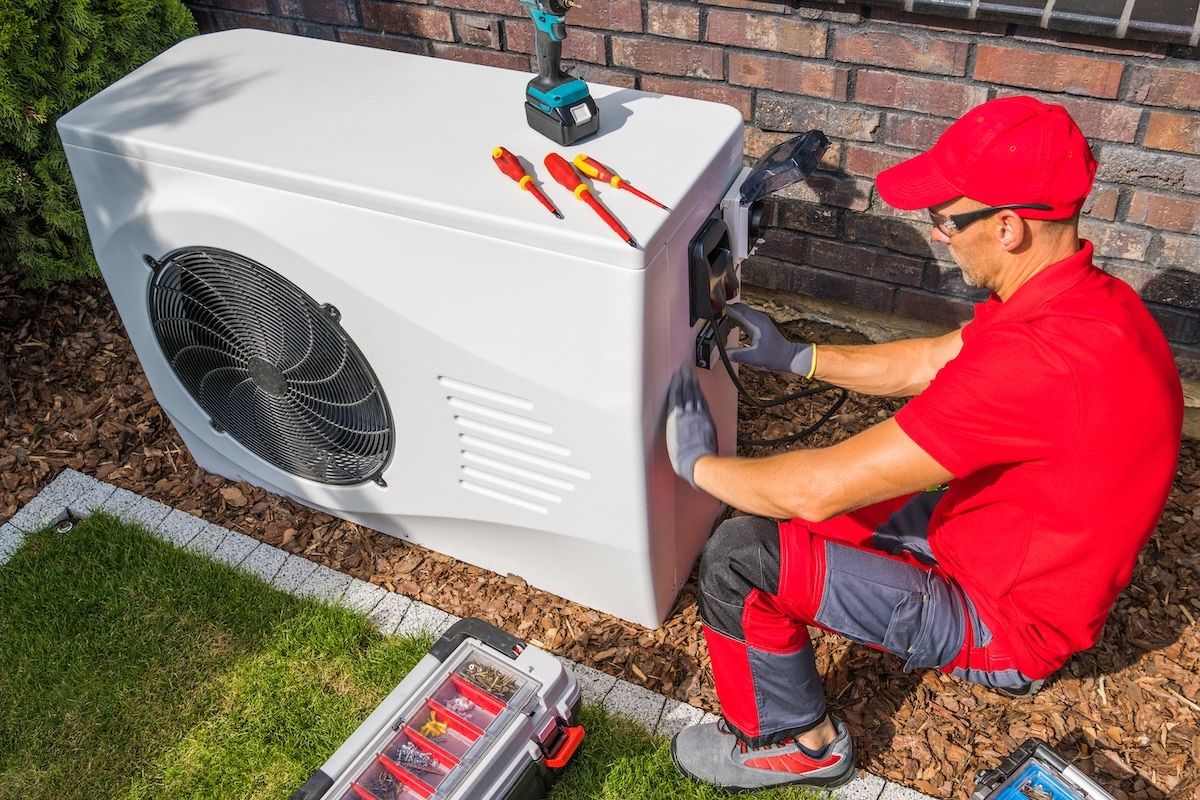 Technician Repairing Heat Pump Unit Technician Repairing Heat Pump Unit