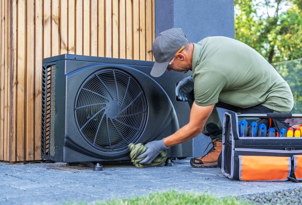 Technician Performs Maintenance on Outdoor Air Conditioning Unit Technician Performs Maintenance on Outdoor Air Conditioning Unit