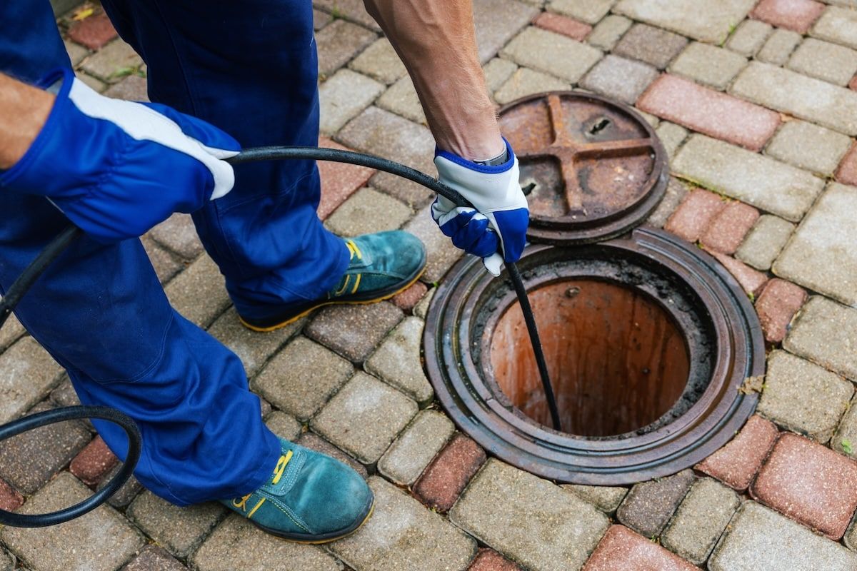 sewer cleaning service - worker clean a clogged drainage with hydro jetting sewer cleaning service - worker clean a clogged drainage with hydro jetting