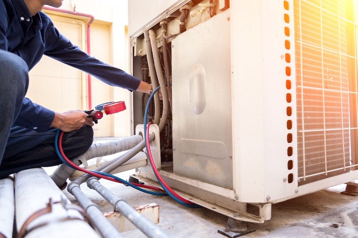 Technician is checking air conditioner ,measuring equipment for filling air conditioners. Technician is checking air conditioner ,measuring equipment for filling air conditioners.