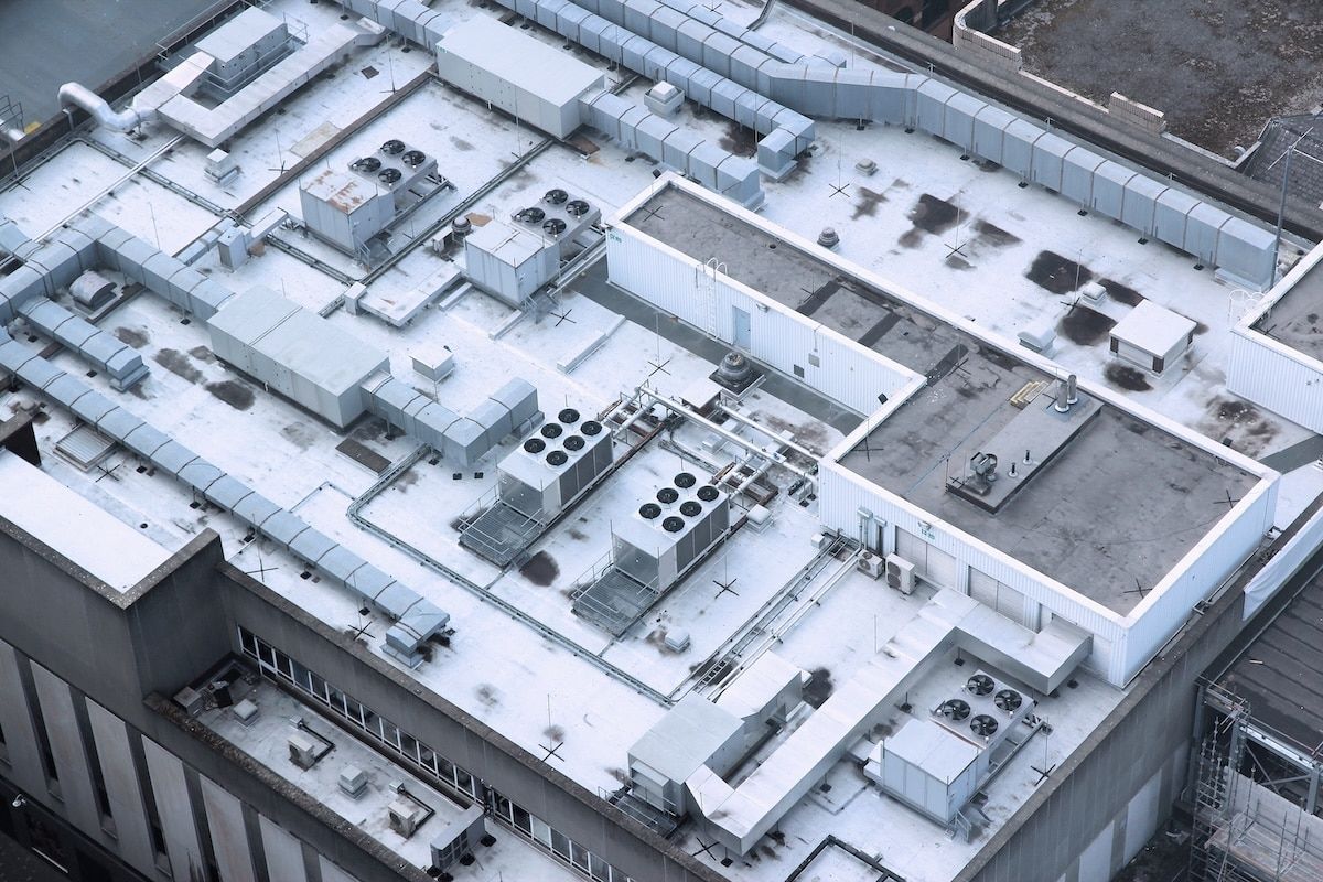 Exhaust vents of industrial air conditioning and ventilation units. Building roof top in Liverpool, UK. Exhaust vents of industrial air conditioning and ventilation units. Building roof top in Liverpool, UK.