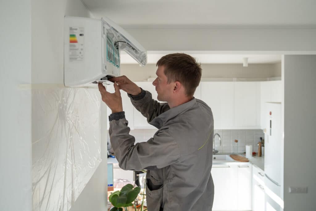 a technician is fixing a HVAC