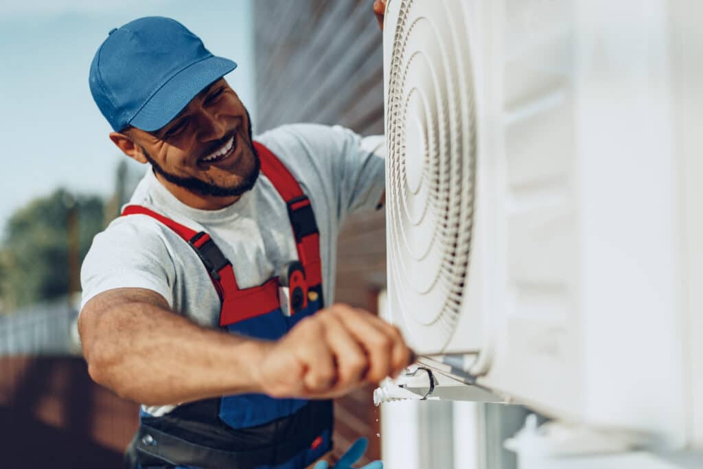 a technician is working on a HVAC system with a smiling face