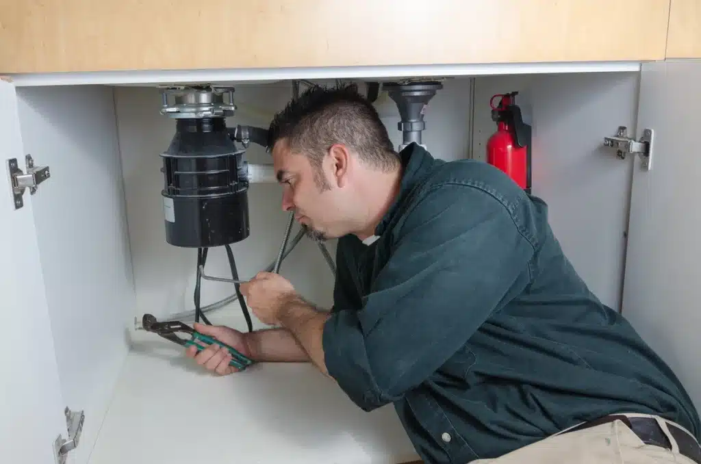garbage disposal being serviced by a professional