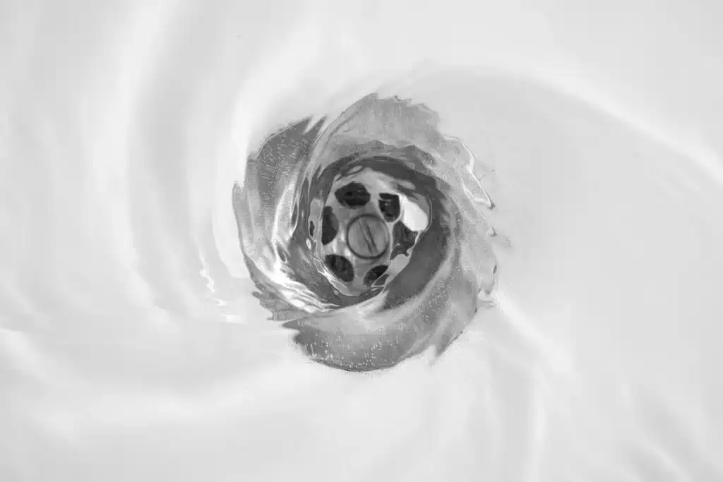 sink drain with water draining in a whirlpool