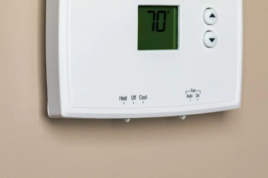 forced air heating-forced air thermostat on a wall