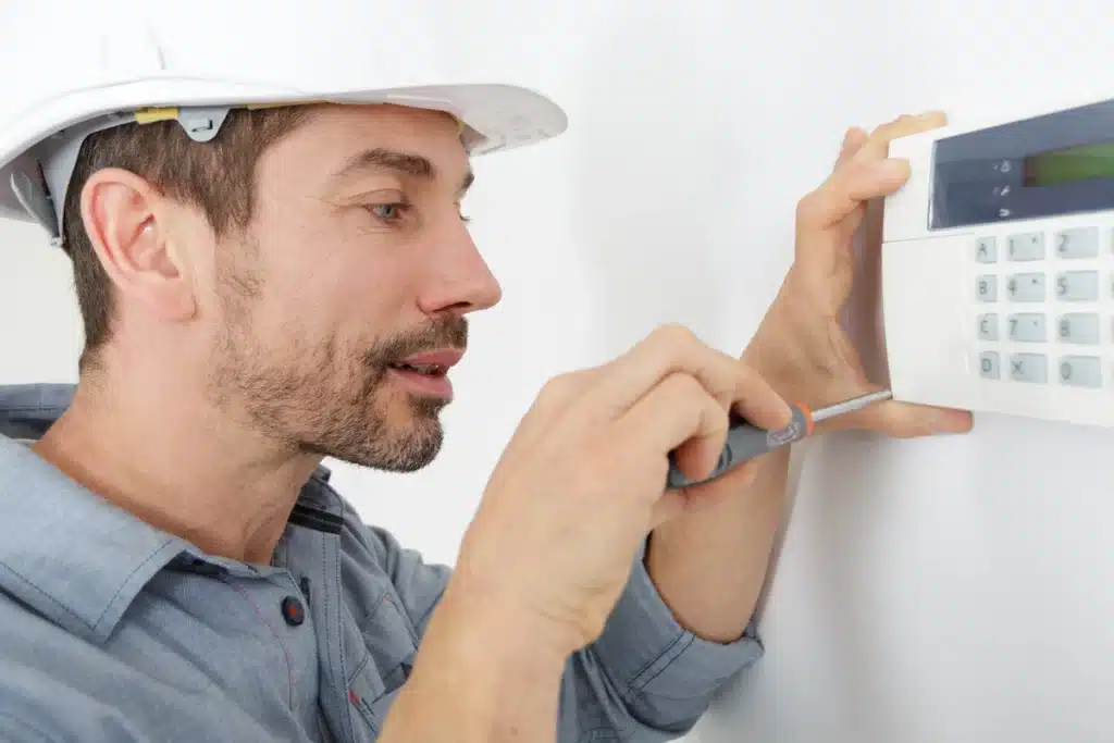 heat not working in house-technician repairing thermostat