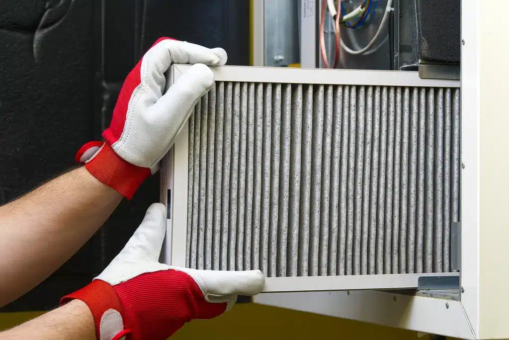 how often to change furnace filter-gloved hands replace furnace filter