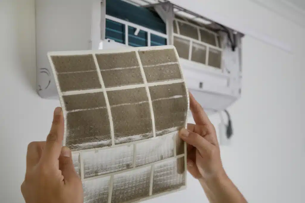 how often to change furnace filter-hands holding a very dirty furnace filter
