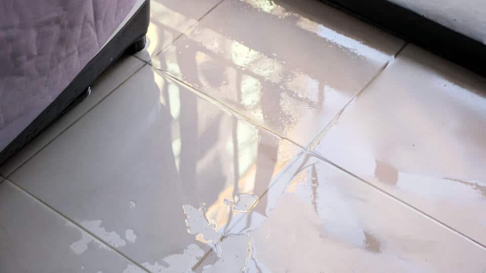 burst pipe repair-water pooling on tile floor from a burst pipe