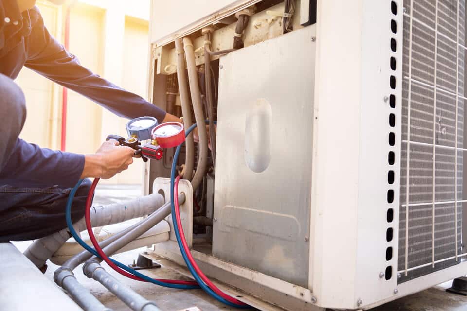 hvac troubleshooting-regular maintenance being performed on an HVAC system