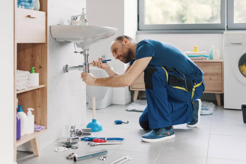 plumbing issues-technician addressing a leaky faucet issue