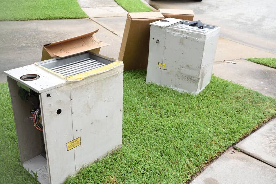 gas furnace replacement cost-old gas furnace on curb for trash pickup
