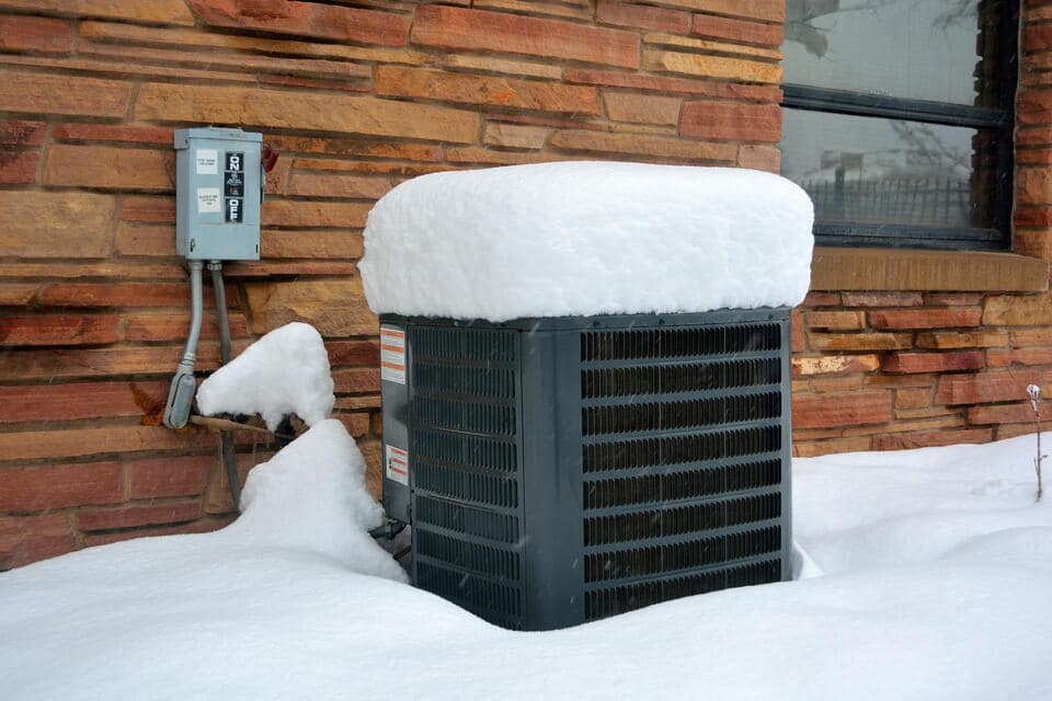 how does a heat pump work in winter-black heat pump outside a stone sided house