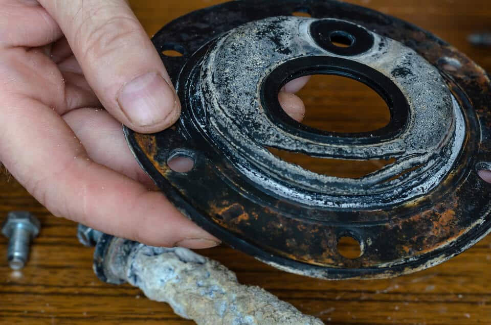 hot water heater leaking-close up of man showing torn rubber gasket for water heater