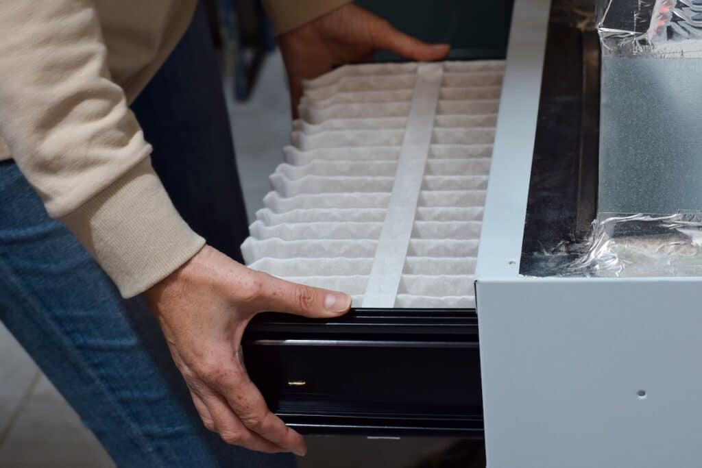 woman replacing air filter 