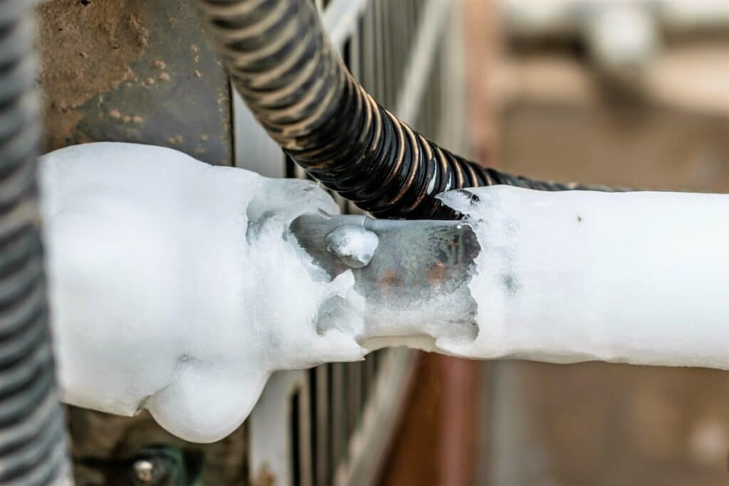 ac cooling air pipes covered by snow or frozen because of super performance of heavy duty central air conditioning system on the roof top in hot summer days