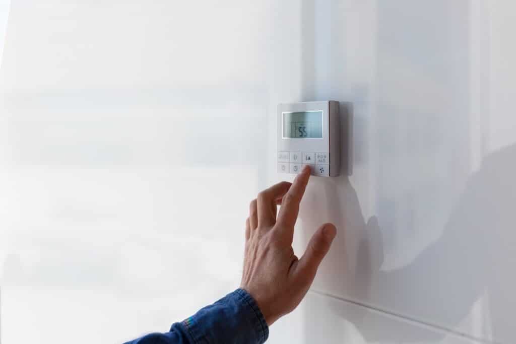 thermostat replacement The air conditioning and heating control panel for the apartment and office is located on a white wall.
